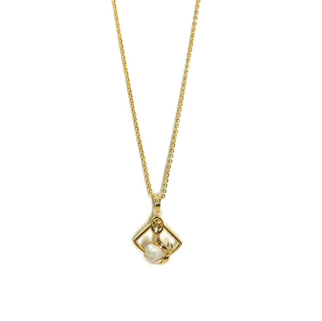 Gold necklace with a pendant on a white background