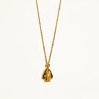 Gold necklace with a pendant on a white background
